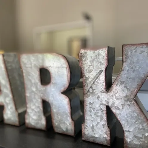 A, R, K letters in metal form.